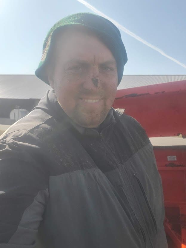 Man in beanie and jacket with dirty face