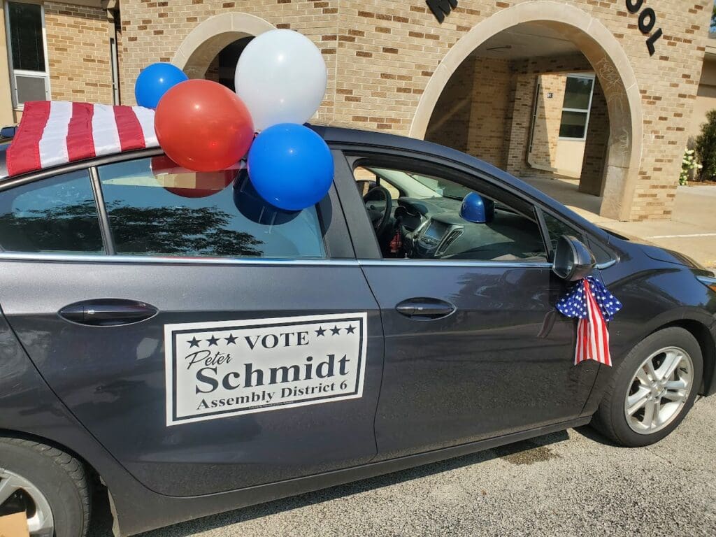 Decorated campaign car with balloons and sign